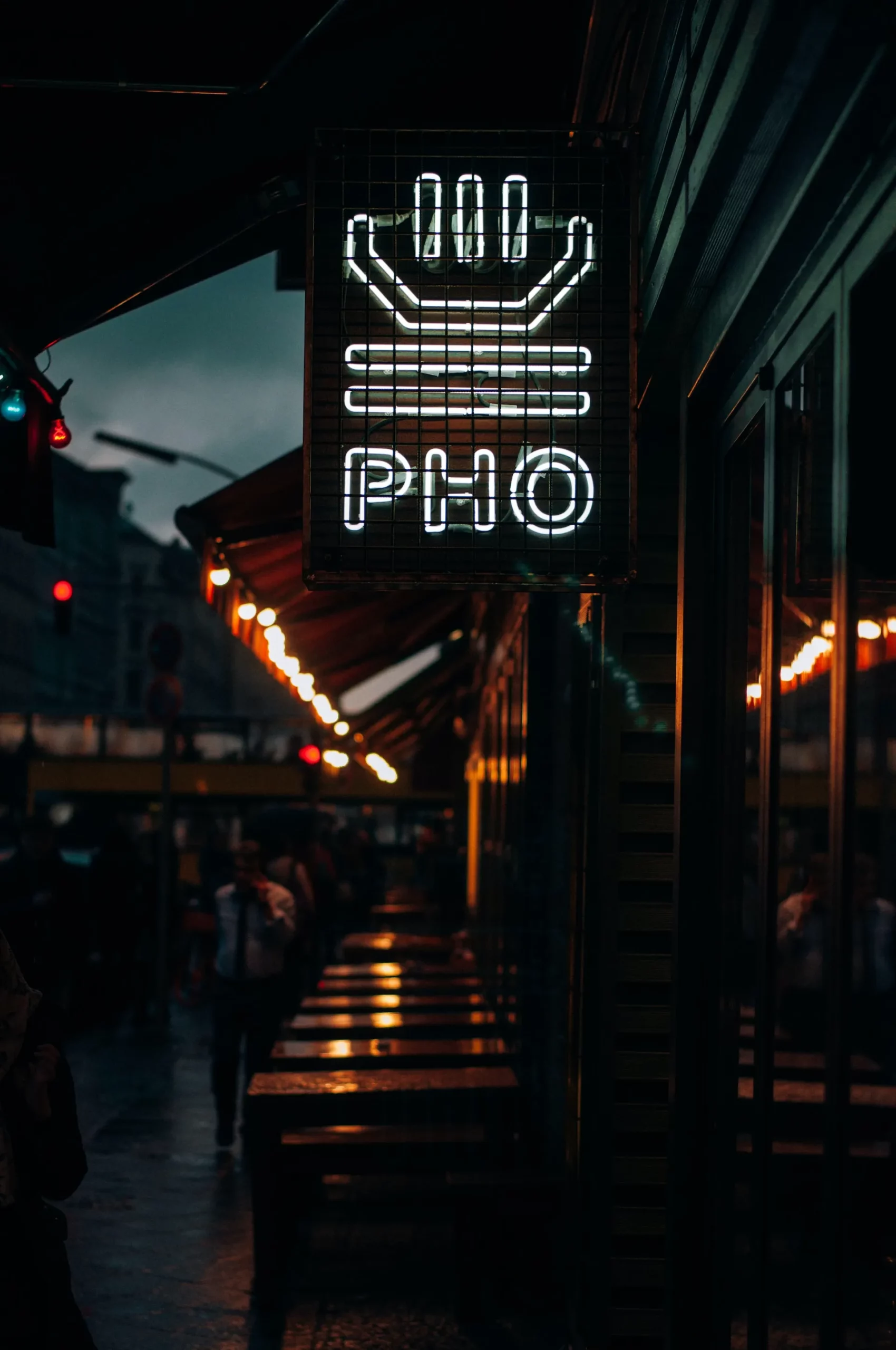 A lit up sign that reads "Pho"